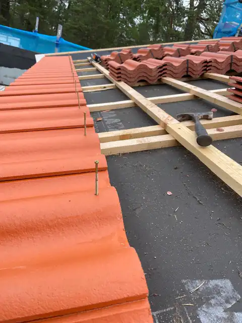 Detalj vid takfoten: underlagstak, läkt och de första pannorna före infästning